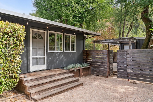 view of outbuilding featuring an outdoor structure and fence