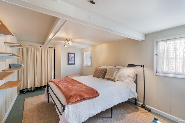 bedroom featuring beamed ceiling, baseboards, and carpet