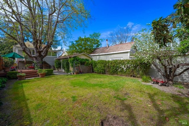view of yard featuring fence and a deck