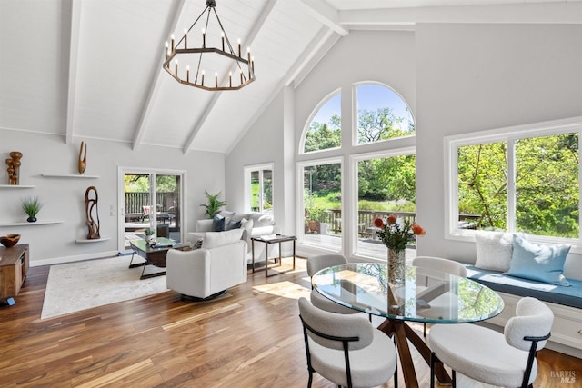 sunroom / solarium with an inviting chandelier and beam ceiling