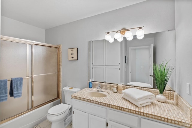 bathroom with combined bath / shower with glass door, vanity, decorative backsplash, and toilet