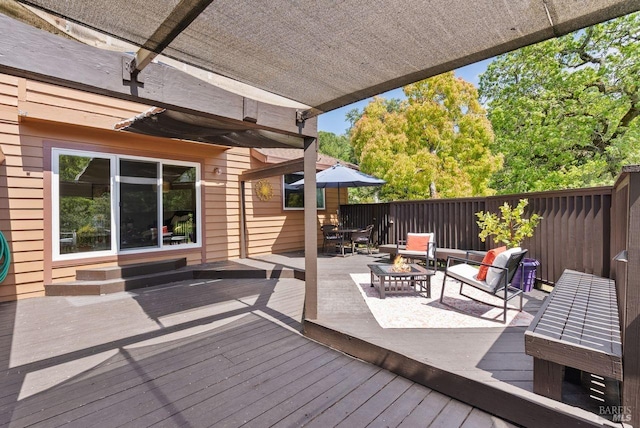 wooden deck with an outdoor fire pit