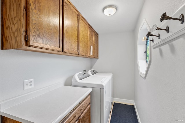 laundry area with baseboards, washer and dryer, and cabinet space