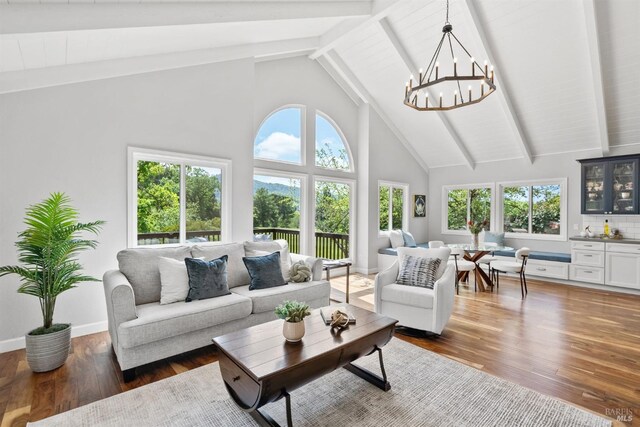 interior space featuring beamed ceiling and a chandelier