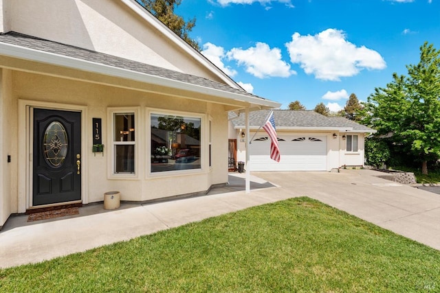 view of front of property with a front lawn, roof with shingles, concrete driveway, and stucco siding