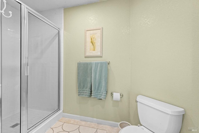 full bathroom with baseboards, toilet, tile patterned floors, and a stall shower
