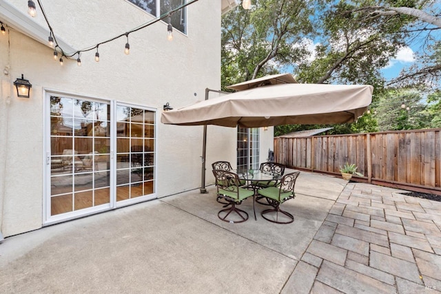 view of patio / terrace featuring fence and outdoor dining area