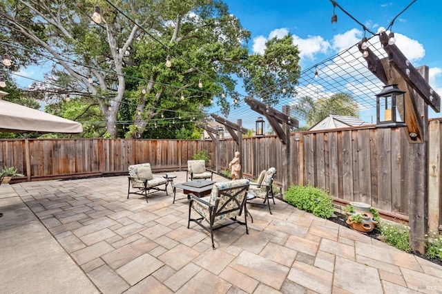 view of patio / terrace with a fenced backyard and a fire pit