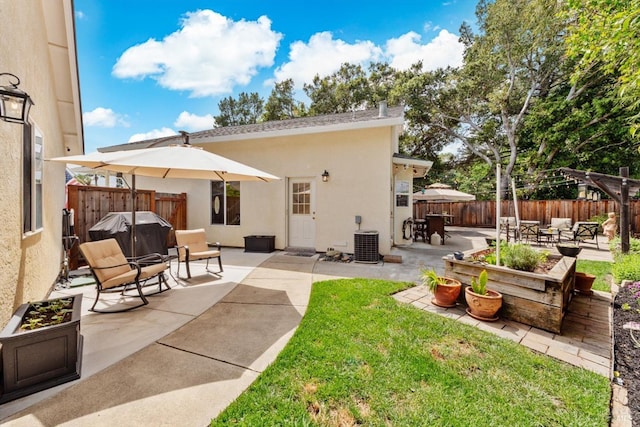 back of house with central AC, a fenced backyard, a patio, and stucco siding