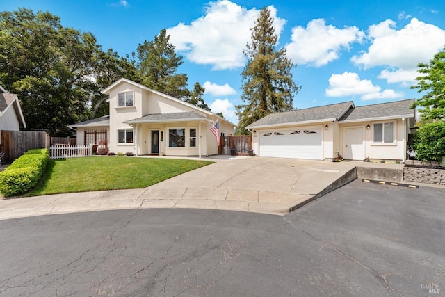 view of front facade featuring fence, a front lawn, concrete driveway, stucco siding, and a garage