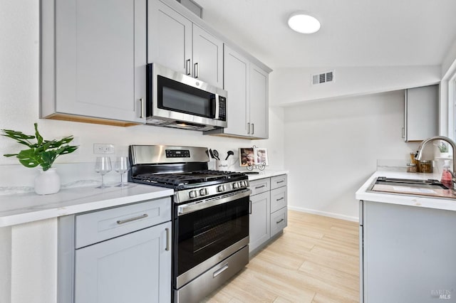 240 Rinaldo Dr, Vallejo, CA 94589 - kitchen with a sink, vaulted ceiling, visible vents, light countertops, and appliances with stainless steel finishes