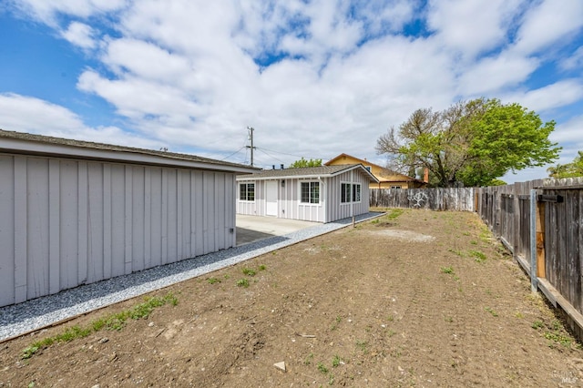 240 Rinaldo Dr, Vallejo, CA 94589 - back of house featuring board and batten siding, a patio, and a fenced backyard