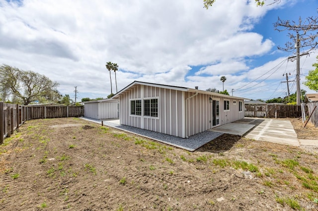 240 Rinaldo Dr, Vallejo, CA 94589 - back of house featuring board and batten siding, a fenced backyard, and a patio