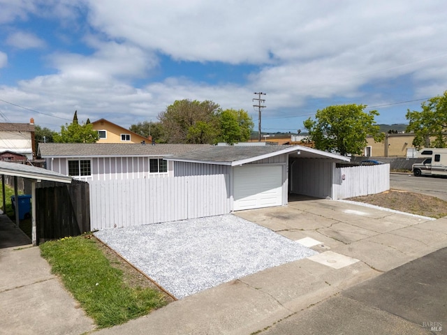 240 Rinaldo Dr, Vallejo, CA 94589 - garage featuring driveway, a carport, and fence