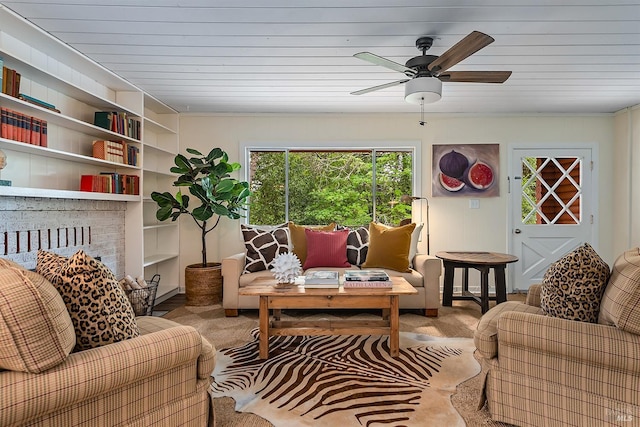living area featuring a ceiling fan, built in features, and wood ceiling