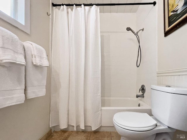 bathroom with tile patterned floors, shower / bath combo, and toilet