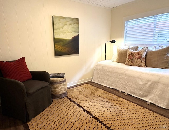 bedroom featuring wood finished floors and baseboards