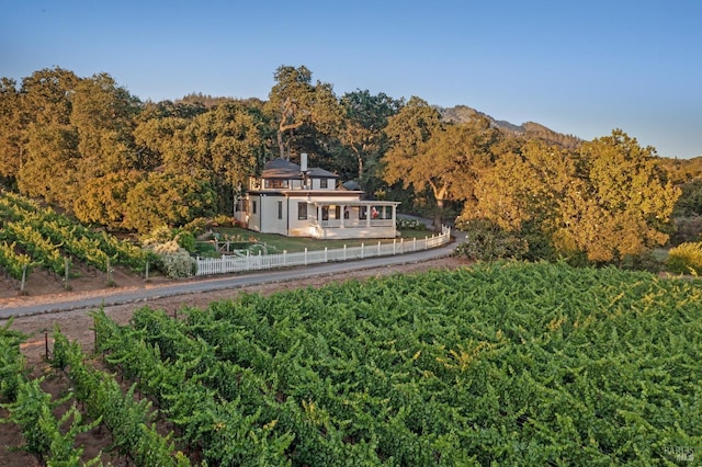 exterior space featuring a forest view and fence
