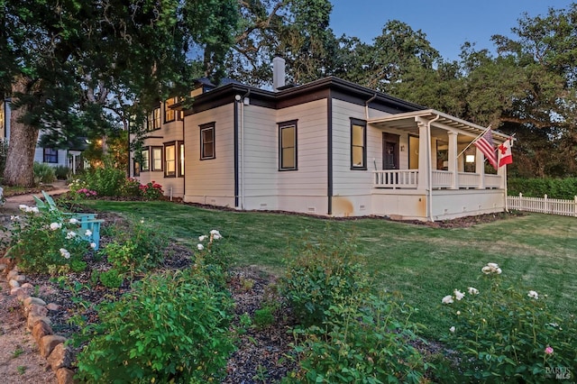 view of property exterior featuring a porch, crawl space, fence, and a yard