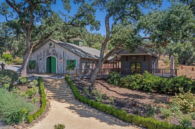 view of front of house with board and batten siding and a wooden deck