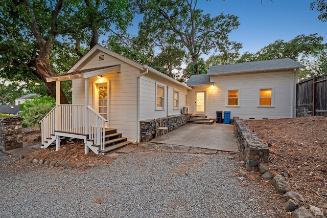 view of front of property with fence and roof with shingles