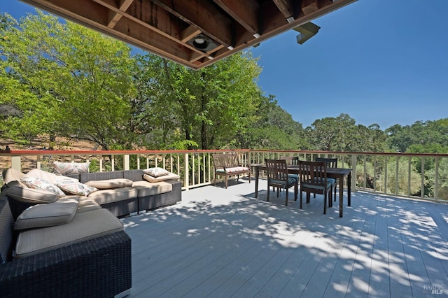 deck with outdoor dining area and outdoor lounge area