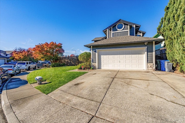 view of front of house featuring fence, driveway, a front lawn, and roof with shingles