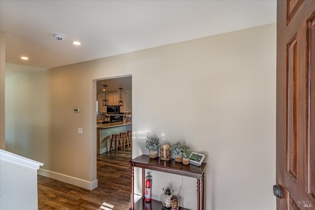 hall with baseboards, dark wood-style floors, and recessed lighting