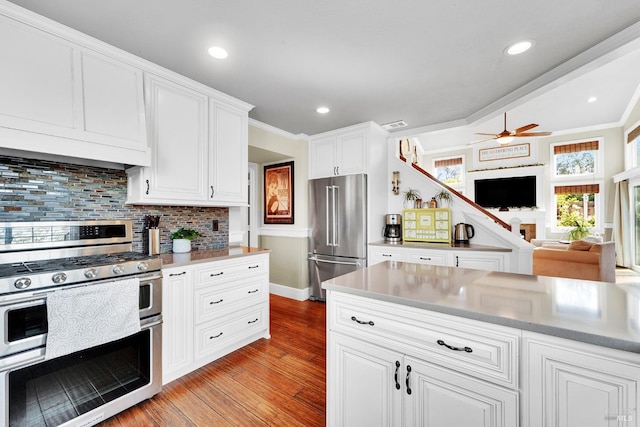 470 Camellia Ct, Benicia, CA 94510 - kitchen with decorative backsplash, light wood-style floors, appliances with stainless steel finishes, ceiling fan, and open floor plan