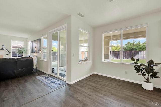 sunroom featuring visible vents and a wealth of natural light