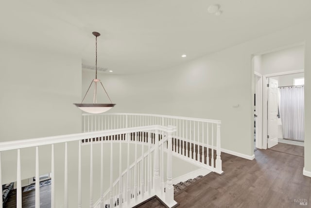 stairs featuring baseboards, wood finished floors, and recessed lighting