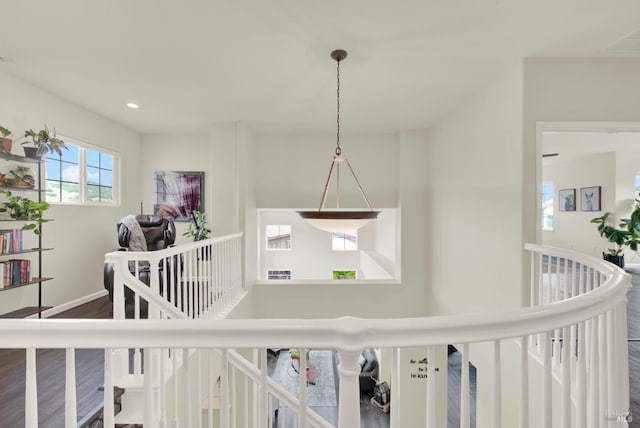 hallway featuring recessed lighting, visible vents, dark wood-style floors, and an upstairs landing