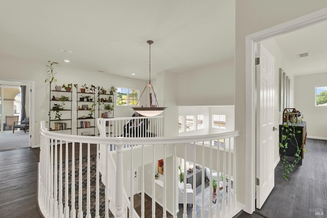 hallway with recessed lighting, visible vents, a wealth of natural light, and dark wood-type flooring