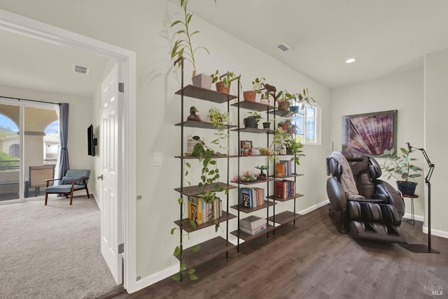 living area with visible vents, plenty of natural light, and baseboards