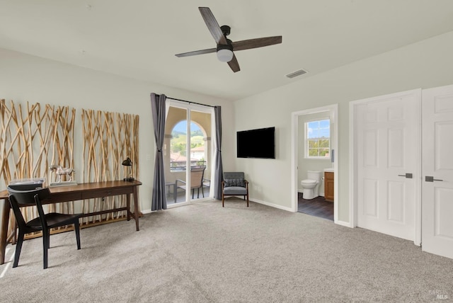 sitting room featuring a wealth of natural light, a ceiling fan, visible vents, and carpet