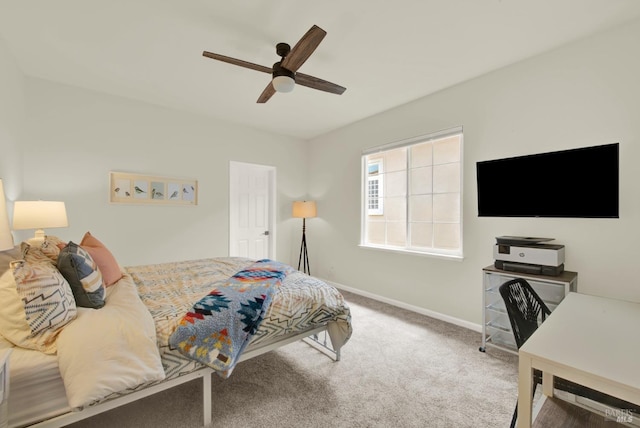 carpeted bedroom featuring a ceiling fan and baseboards
