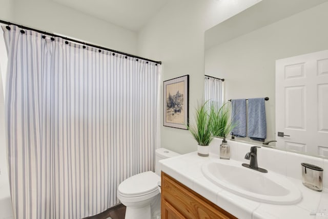 full bathroom featuring vanity, curtained shower, and toilet