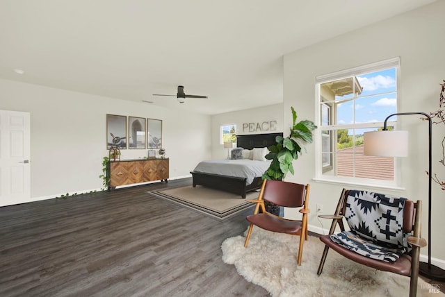 bedroom featuring baseboards, wood finished floors, and ceiling fan