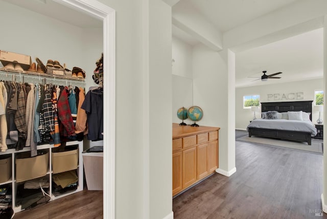 interior space featuring baseboards and wood finished floors