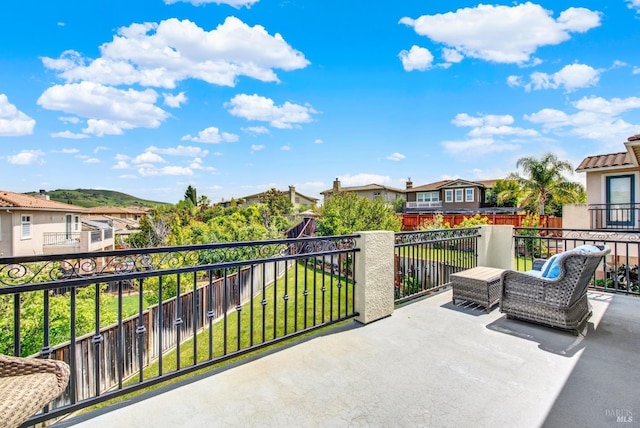 view of patio with a residential view and a balcony
