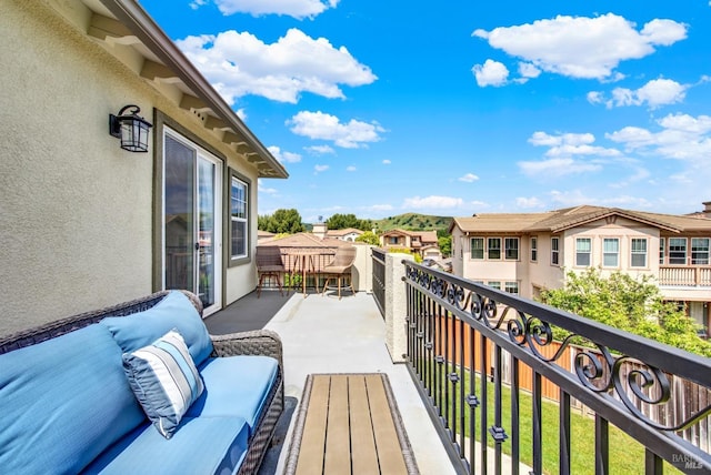 balcony featuring an outdoor living space and a residential view