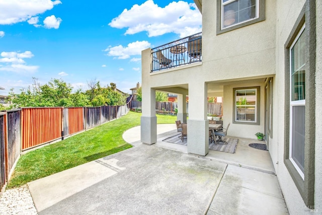 view of patio with a fenced backyard and outdoor dining area