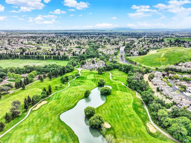 drone / aerial view with golf course view, a water view, and a residential view