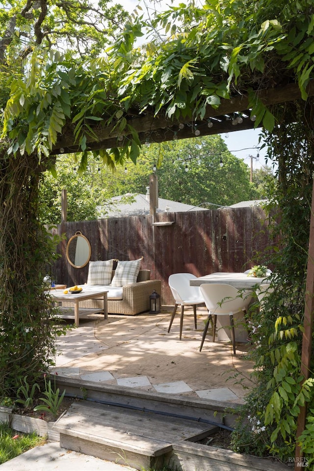 view of patio featuring fence