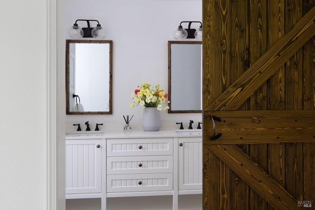 bathroom featuring a sink and double vanity