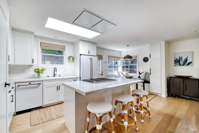 11 Cedar St, San Anselmo, CA 94960 - kitchen featuring white cabinets, a sink, white appliances, and light wood-style floors