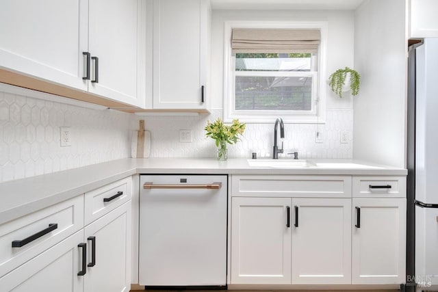 11 Cedar St, San Anselmo, CA 94960 - kitchen featuring a sink, white dishwasher, freestanding refrigerator, tasteful backsplash, and white cabinetry