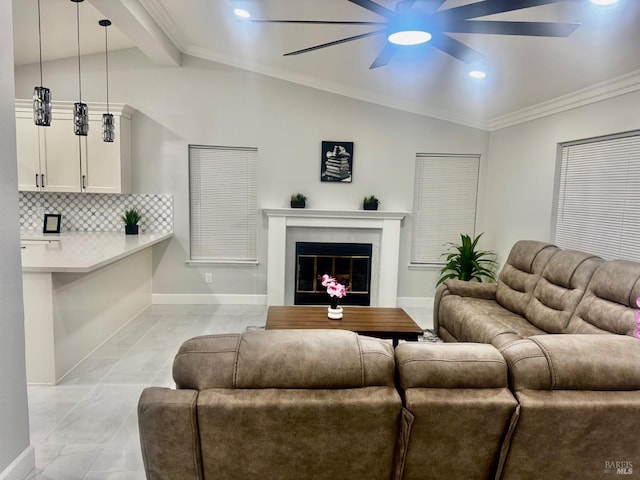 living area with crown molding, lofted ceiling with beams, a glass covered fireplace, ceiling fan, and baseboards