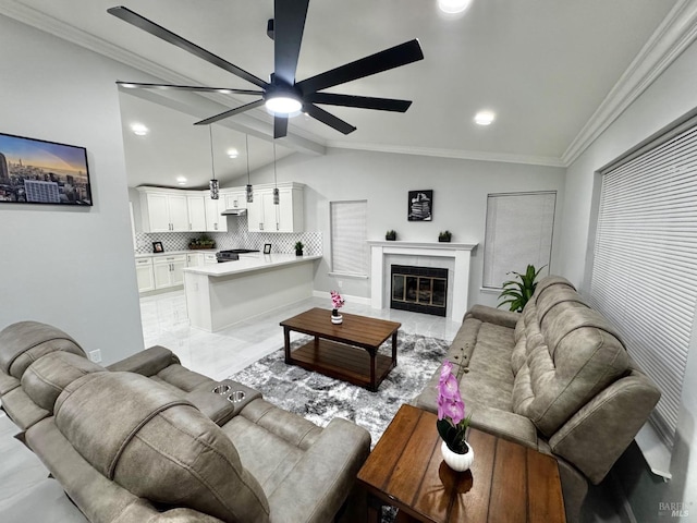 living area featuring recessed lighting, vaulted ceiling with beams, crown molding, a tiled fireplace, and ceiling fan