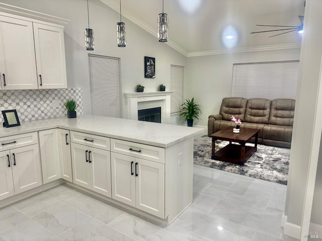 kitchen featuring open floor plan, marble finish floor, a fireplace, white cabinets, and a peninsula